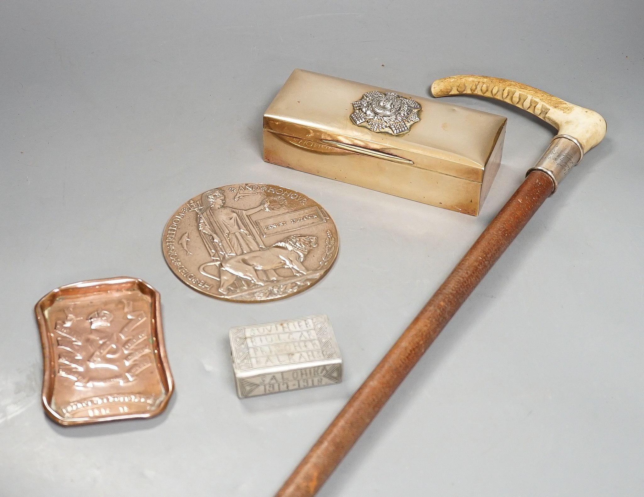 World War memorabilia, riding crop, ash tray, POW match case, 74th Highlanders brass case and a memorial plaque, Highlanders case 17cms wide.